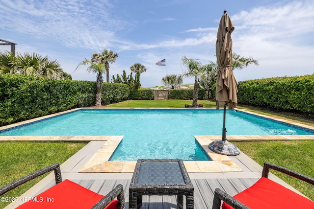 view of swimming pool featuring a fenced in pool and a yard