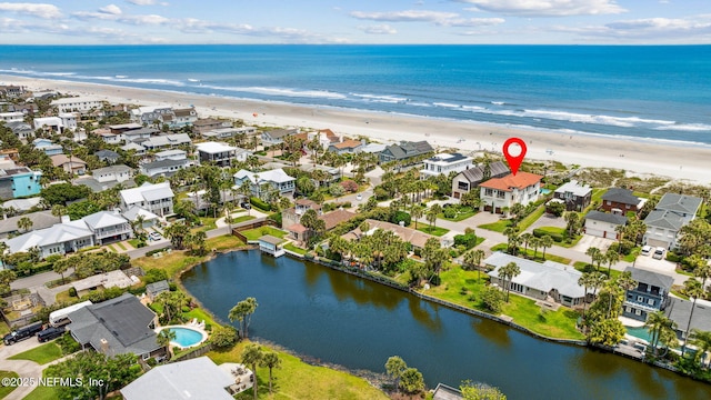 birds eye view of property with a water view, a residential view, and a view of the beach