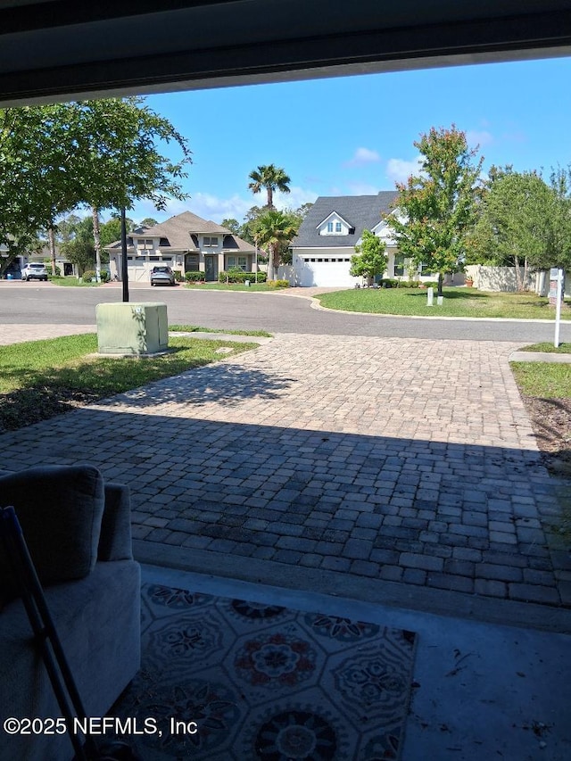 view of patio with driveway and a residential view