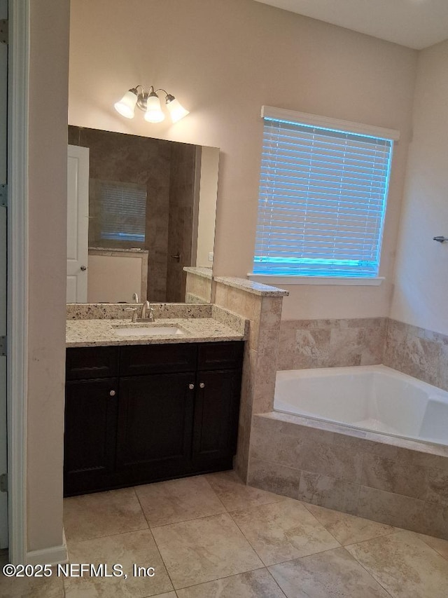 bathroom with vanity, a garden tub, and tile patterned floors