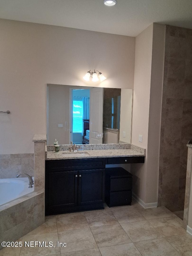 bathroom with vanity, tile patterned flooring, and a bath