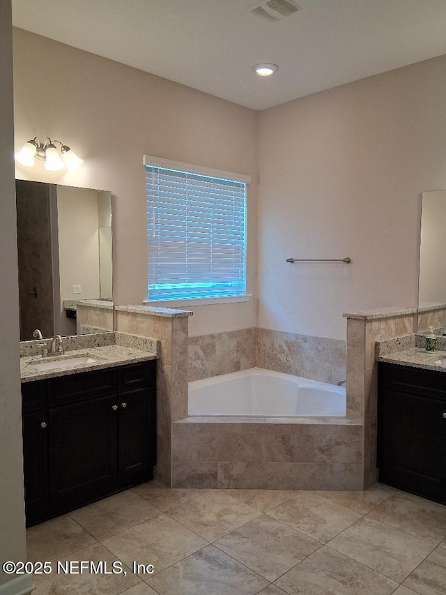 bathroom with vanity, a garden tub, tile patterned floors, and visible vents