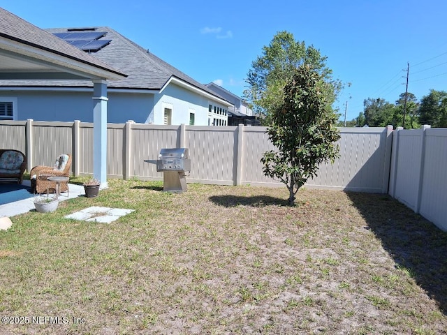 view of yard with a fenced backyard