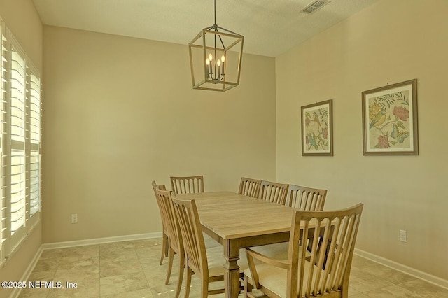 2924 Sea Grape Dr S, Fernandina Beach, FL 32034 - dining area with a chandelier, baseboards, and light tile patterned flooring