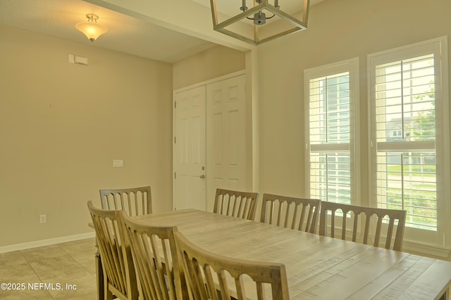2924 Sea Grape Dr S, Fernandina Beach, FL 32034 - dining area with baseboards, a chandelier, and light tile patterned floors