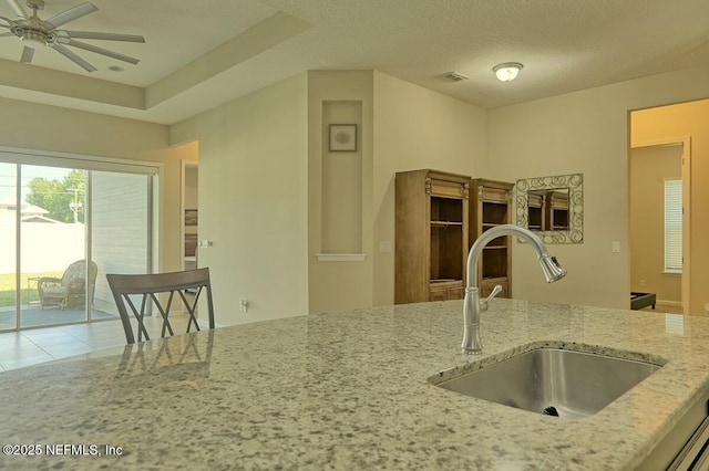 2924 Sea Grape Dr S, Fernandina Beach, FL 32034 - kitchen with a sink, light stone countertops, a ceiling fan, and tile patterned floors