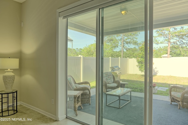 2924 Sea Grape Dr S, Fernandina Beach, FL 32034 - doorway to outside with healthy amount of natural light, baseboards, and tile patterned flooring