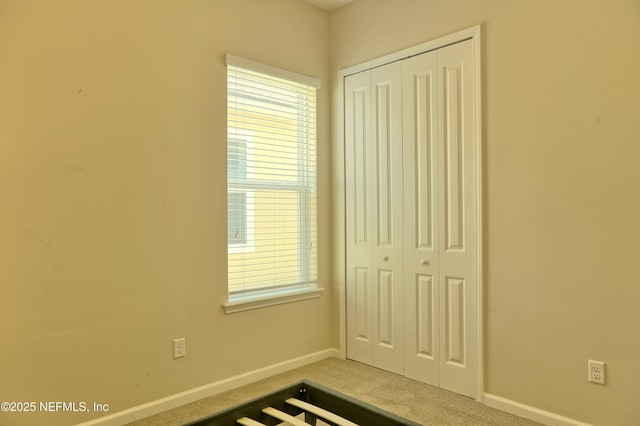 2924 Sea Grape Dr S, Fernandina Beach, FL 32034 - unfurnished bedroom featuring a closet, baseboards, and carpet floors