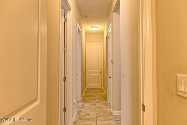 2924 Sea Grape Dr S, Fernandina Beach, FL 32034 - hall featuring a textured ceiling and baseboards