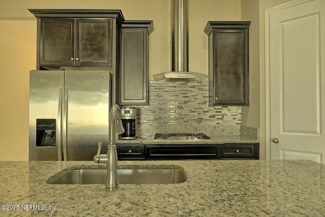 2924 Sea Grape Dr S, Fernandina Beach, FL 32034 - kitchen featuring stainless steel appliances, wall chimney exhaust hood, light stone countertops, and decorative backsplash