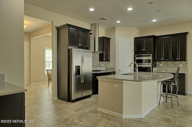 2924 Sea Grape Dr S, Fernandina Beach, FL 32034 - kitchen featuring stainless steel appliances, a sink, wall chimney range hood, tasteful backsplash, and recessed lighting