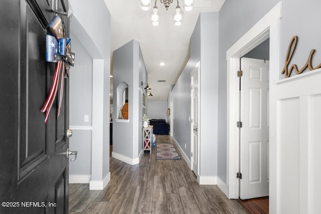 45103 Amhurst Oaks Dr, Callahan, FL 32011 - hall featuring wood finished floors, a chandelier, baseboards, and recessed lighting