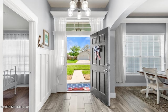 45103 Amhurst Oaks Dr, Callahan, FL 32011 - entryway featuring a chandelier, wood finished floors, and plenty of natural light