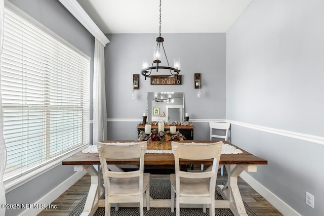 45103 Amhurst Oaks Dr, Callahan, FL 32011 - dining space with a chandelier, wood finished floors, and baseboards