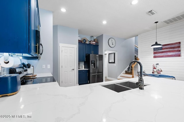 45103 Amhurst Oaks Dr, Callahan, FL 32011 - kitchen featuring stainless steel fridge, a sink, blue cabinetry, electric stove, and hanging light fixtures