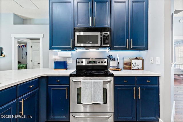 45103 Amhurst Oaks Dr, Callahan, FL 32011 - kitchen with appliances with stainless steel finishes, blue cabinets, and light countertops