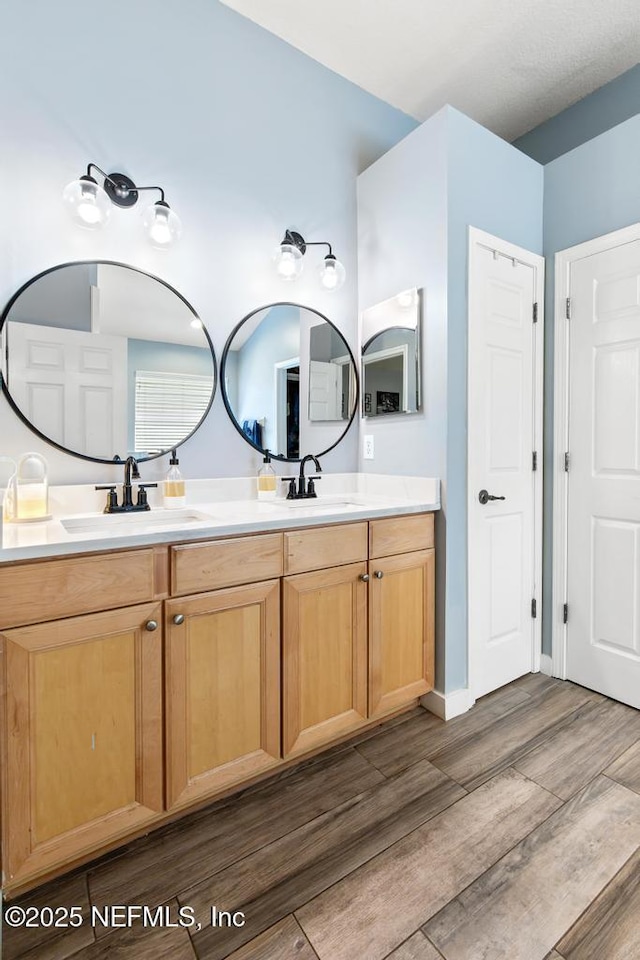 45103 Amhurst Oaks Dr, Callahan, FL 32011 - bathroom with wood finished floors and double vanity