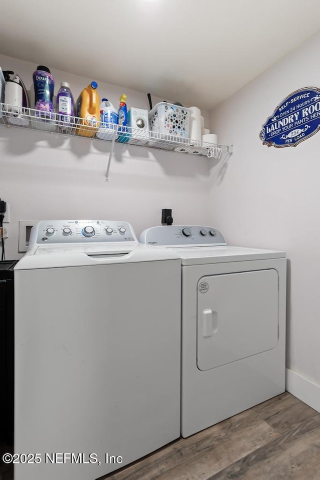 45103 Amhurst Oaks Dr, Callahan, FL 32011 - laundry area with washer and dryer and wood finished floors