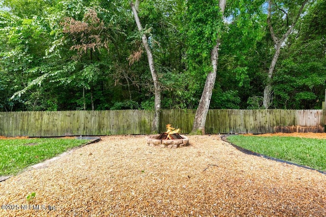 45103 Amhurst Oaks Dr, Callahan, FL 32011 - fenced backyard featuring an outdoor fire pit