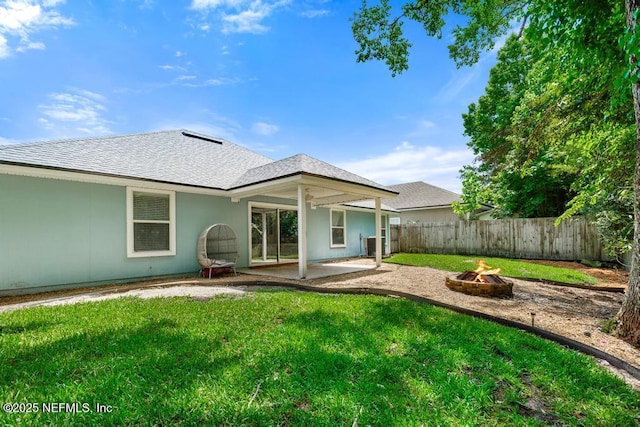 45103 Amhurst Oaks Dr, Callahan, FL 32011 - back of house featuring an outdoor fire pit, a patio area, roof with shingles, and central air condition unit