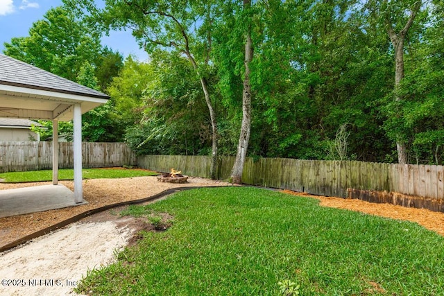 45103 Amhurst Oaks Dr, Callahan, FL 32011 - view of yard featuring a patio area and an outdoor fire pit