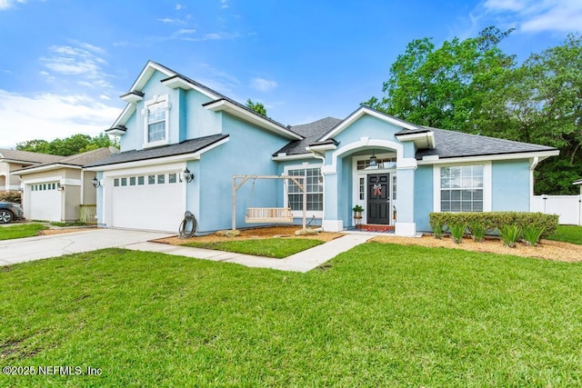 45103 Amhurst Oaks Dr, Callahan, FL 32011 - view of front facade featuring driveway, a garage, stucco siding, and roof with shingles