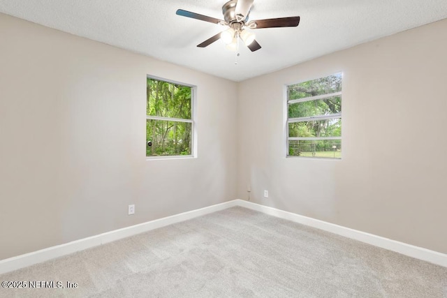 spare room with baseboards, ceiling fan, and carpet floors