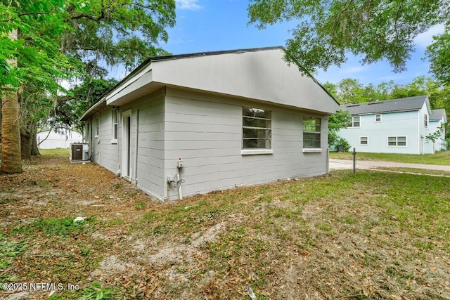 view of home's exterior featuring central air condition unit and a yard