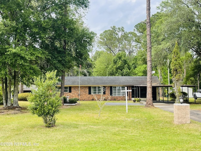 view of front of home featuring asphalt driveway, a carport, a front yard, and brick siding