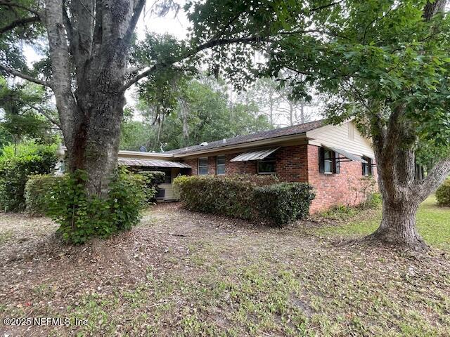 view of property exterior featuring brick siding