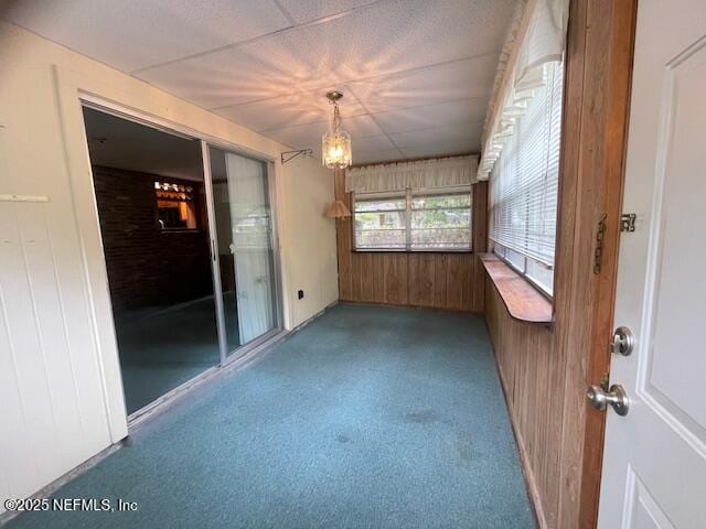 spare room featuring wooden walls