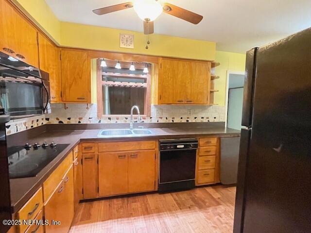 kitchen with black appliances, a sink, ceiling fan, open shelves, and light wood-style floors