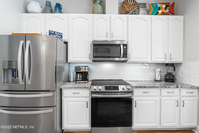 1421 Kipling Ln, Ponte Vedra, FL 32081 - kitchen with stainless steel appliances and white cabinetry