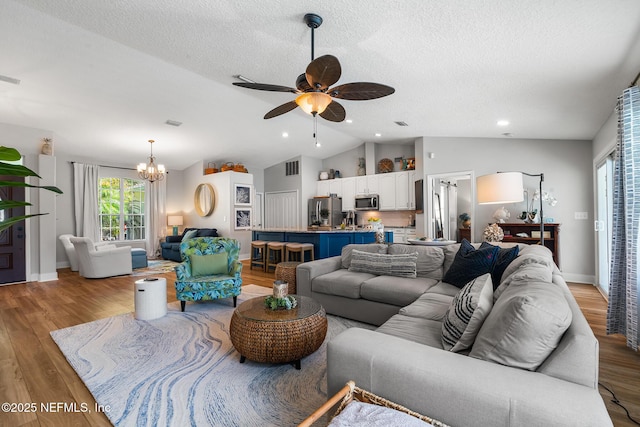 1421 Kipling Ln, Ponte Vedra, FL 32081 - living area featuring lofted ceiling, a chandelier, ceiling fan, light wood finished floors, and a textured ceiling