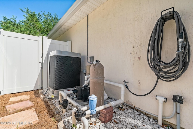 1421 Kipling Ln, Ponte Vedra, FL 32081 - exterior view of stucco siding, central AC unit, pump, and fence