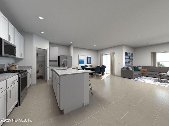 kitchen with a sink, a wealth of natural light, open floor plan, and stainless steel appliances