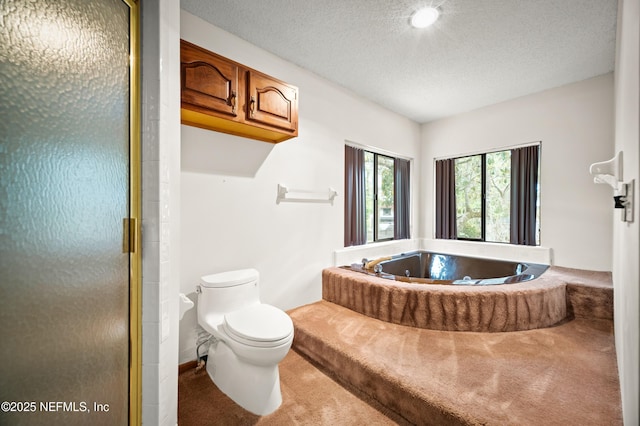 full bath featuring a textured ceiling, a shower stall, toilet, and a bath
