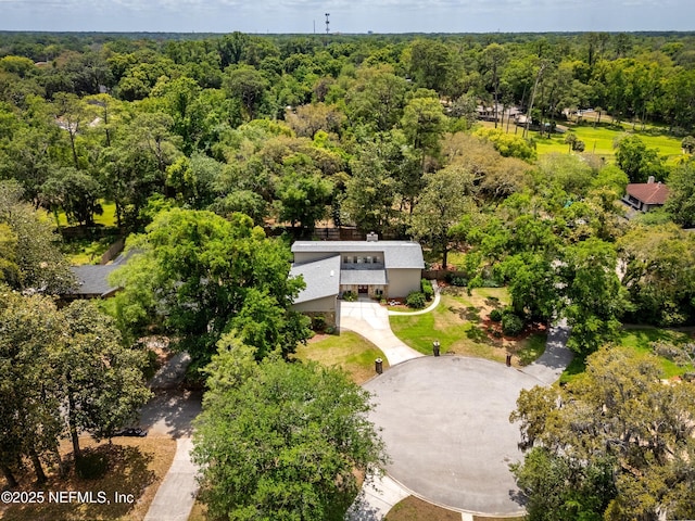 drone / aerial view featuring a wooded view