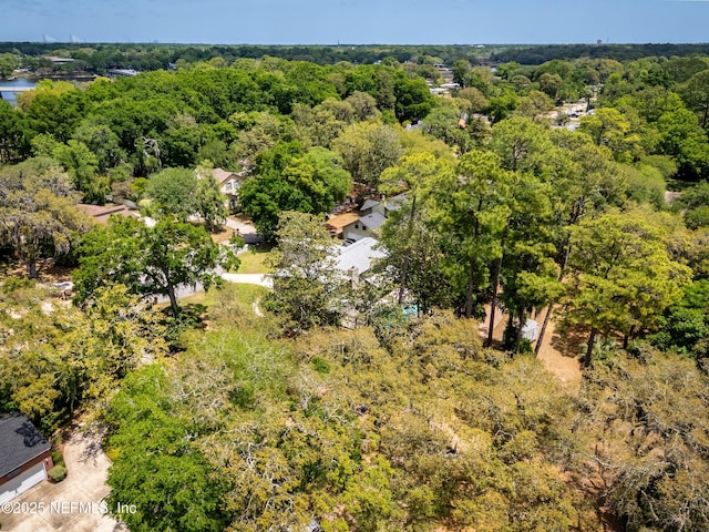 birds eye view of property with a forest view