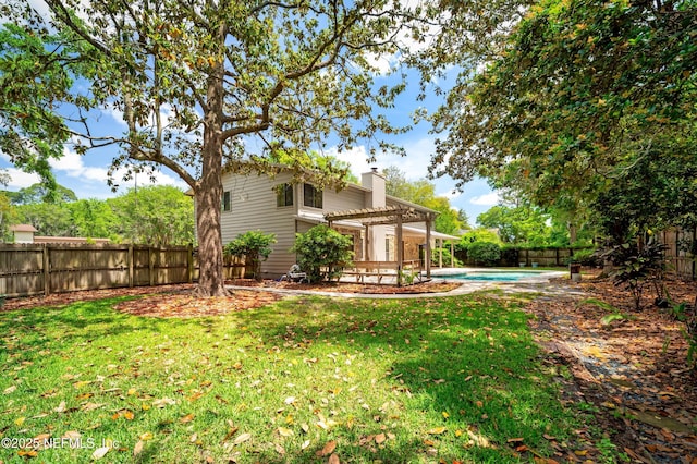 view of yard with a fenced in pool, a fenced backyard, and a pergola