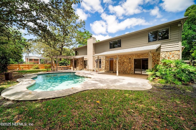 back of property featuring a pergola, a fenced backyard, a fenced in pool, a chimney, and a patio