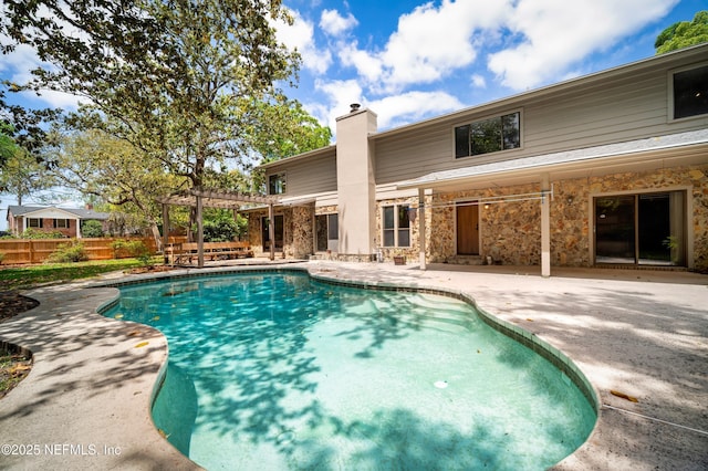 view of pool featuring a fenced in pool, a patio area, fence, and a pergola