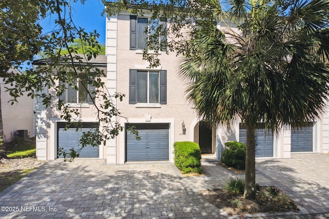 4746 Gulfstream Ct, Fernandina Beach, FL 32034 - view of front of home featuring central air condition unit, stucco siding, an attached garage, and decorative driveway