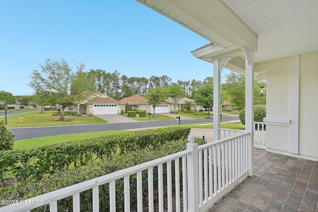 1201 Coghill Cir, Saint Augustine, FL 32092 - view of patio with a residential view, a porch, and a garage