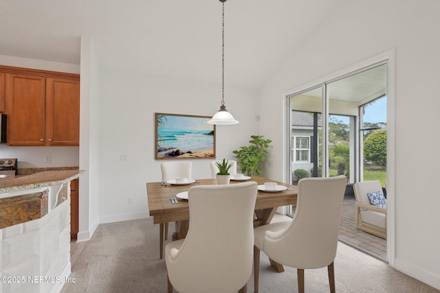1201 Coghill Cir, Saint Augustine, FL 32092 - dining area with baseboards, light colored carpet, and vaulted ceiling