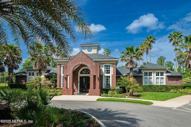 view of front facade featuring french doors and brick siding