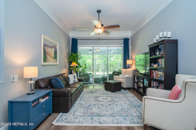 living room featuring crown molding, a textured ceiling, ceiling fan, and wood finished floors