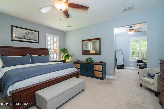 bedroom with baseboards, multiple windows, carpet, and visible vents