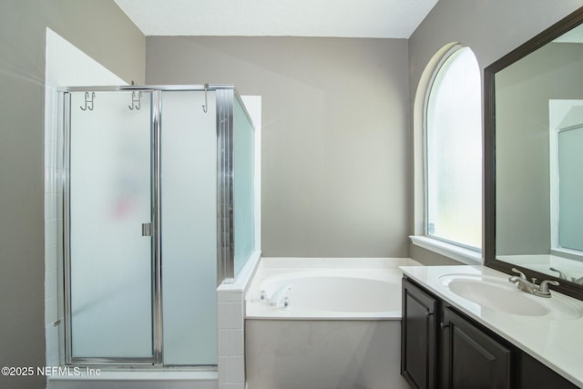 bathroom with vanity, a bath, and a stall shower