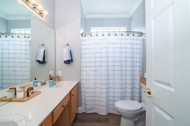 full bath featuring crown molding, double vanity, a sink, and wood finished floors